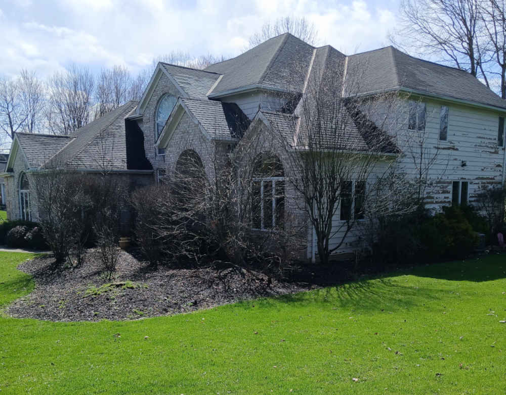 Large home in Solon, Ohio before painting, showing peeling paint on exterior.