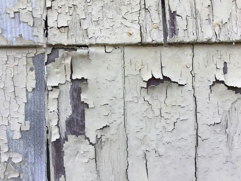 Photos showing cracked and blistering paint up-close on wood.